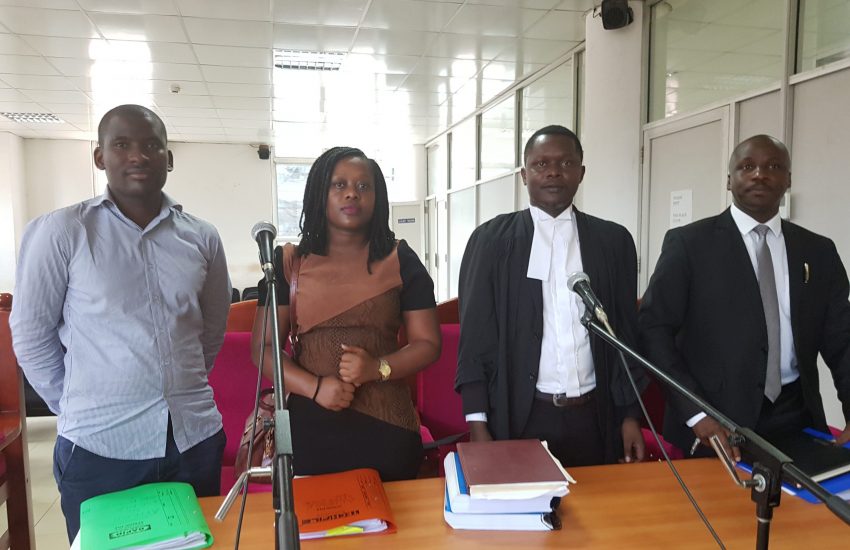 Four Ugandan people in a court room during a legal case to protect ecosensitive areas from oil threats.