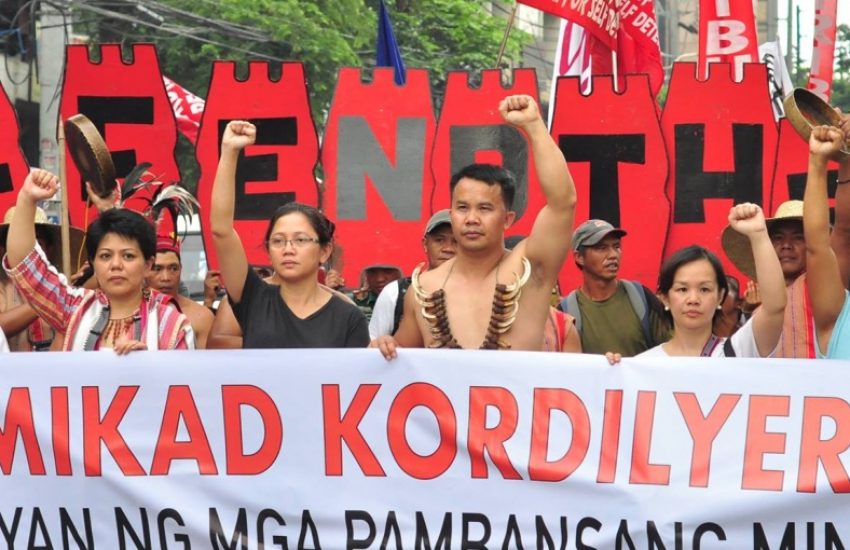 Group of people from Cordillera Peoples Alliance holding a large protesting sign. (Photo: Cordillera Peoples Alliance)