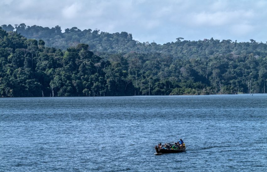 Men on boat on Brokopondo Lake Suriname